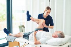 Physical therapy doctor with senior male patient