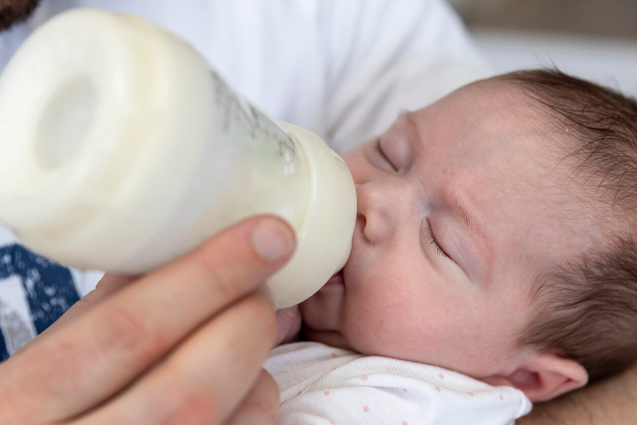 Preemie baby being fed with bottle