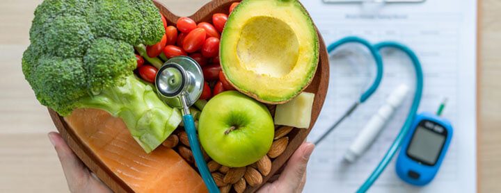 Heart shaped bowl of fruit and a stethoscope