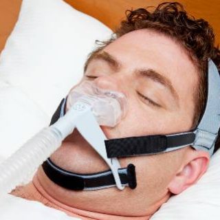 Man sleeping with CPAP machine