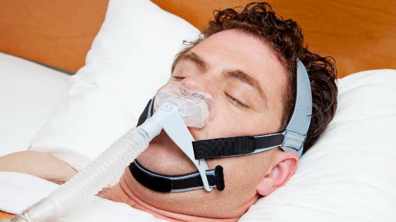 Man sleeping with CPAP machine