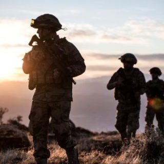 Soldiers walking at sunset