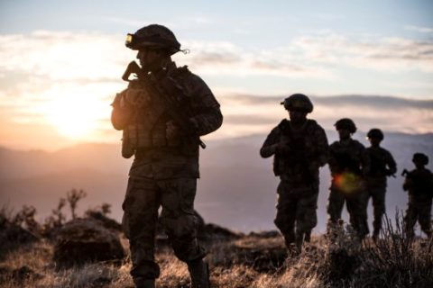 Soldiers walking at sunset