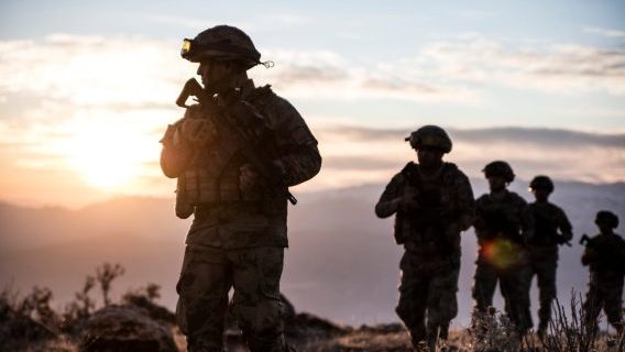 Soldiers walking at sunset