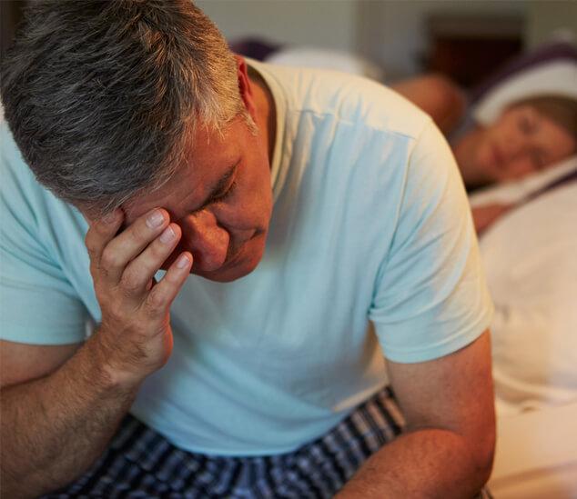 Restless Man on Edge of Bed