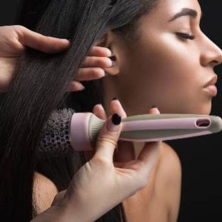 Woman styling straight hair