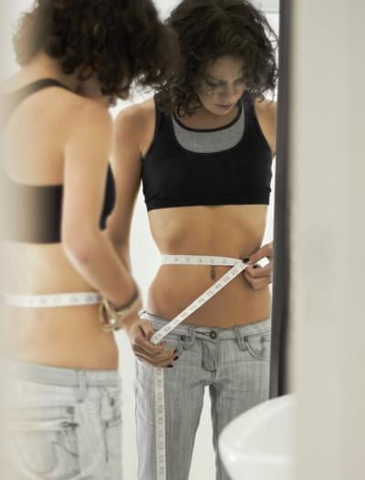 Female measuring her waist line