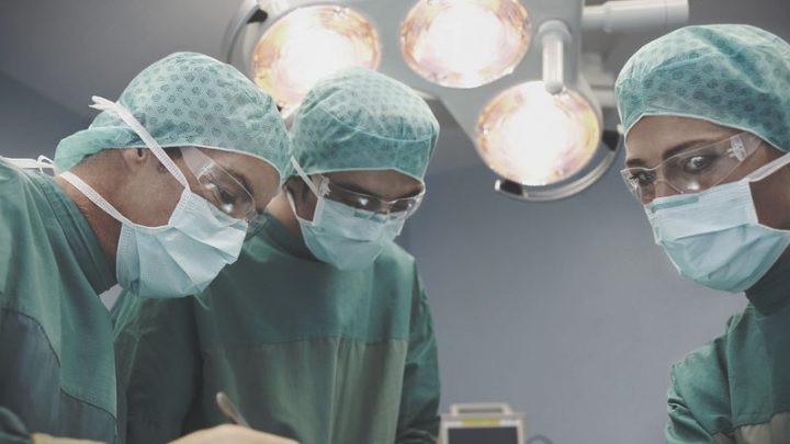 surgeons Doctors completing surgical procedure