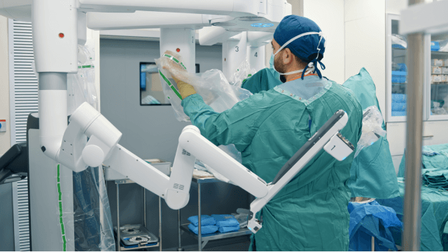 Doctor preparing robotic surgery equipment
