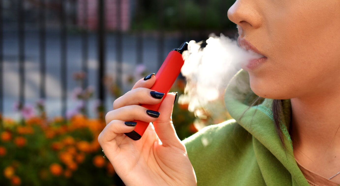 Girl smoking red e-cigarette