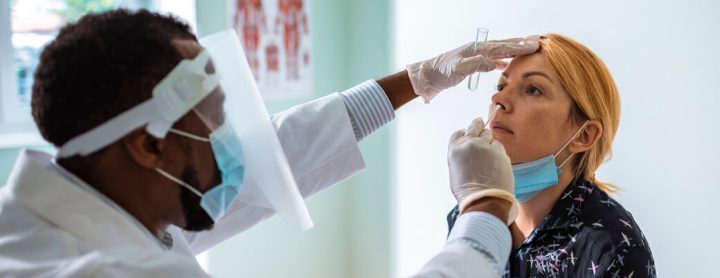 Woman receiving a nasal swab to test for COVID