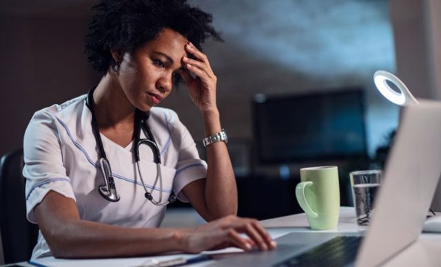 Tired female doctor working late