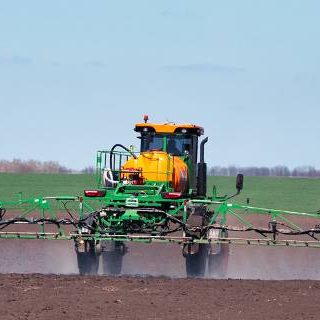 Tractor spraying fields