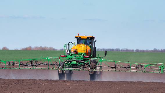 Tractor spraying fields