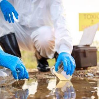 Workers in hazmat suits testing water
