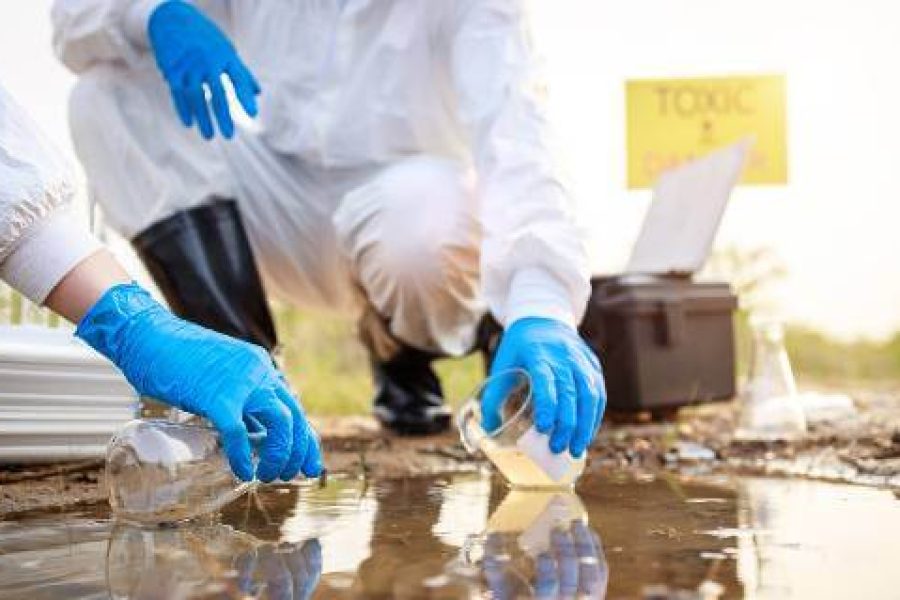 Workers in hazmat suits testing water