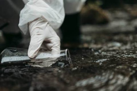 White gloved hand testing water