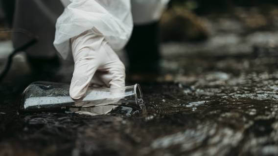 White gloved hand testing water