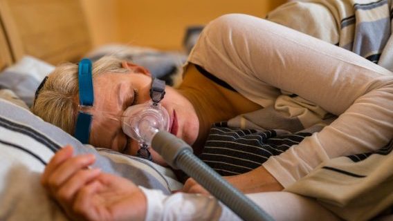 Woman using a CPAP machine