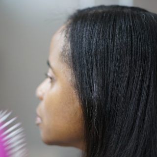 Young woman with straight hair and brush