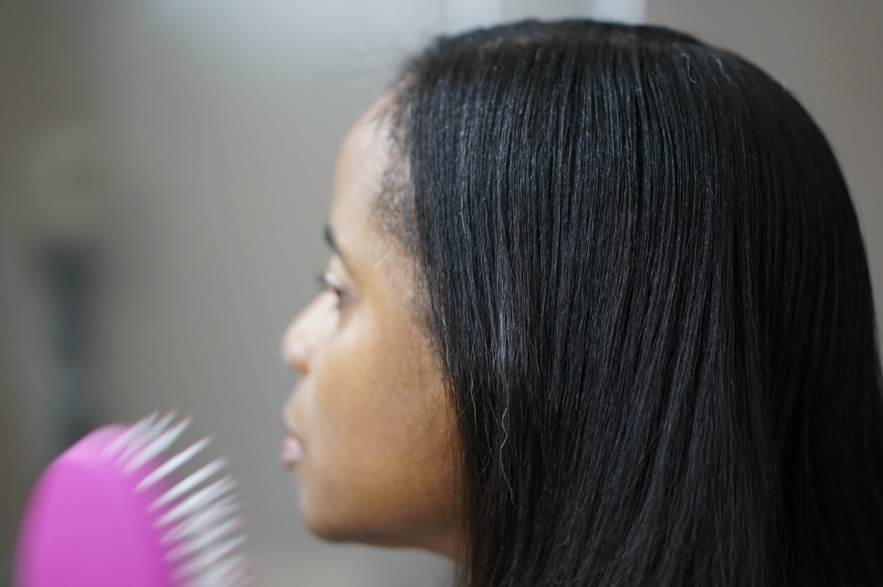 Young woman with straight hair and brush