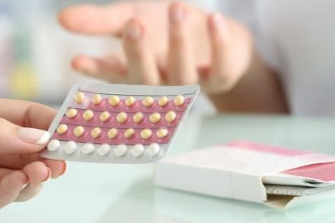 people handling birth control pills