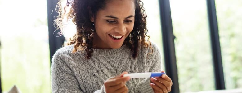 woman checking pregnancy test