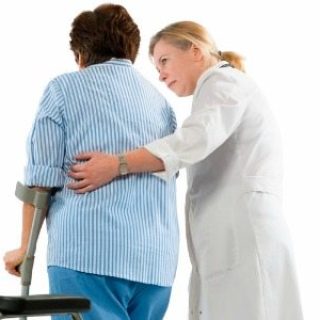 doctor helps a woman with crutches