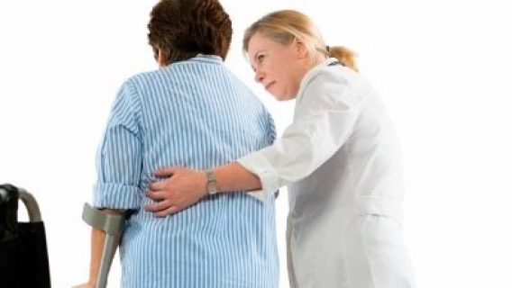 doctor helps a woman with crutches