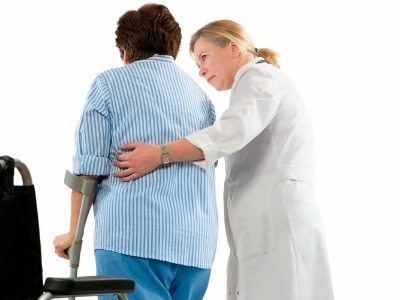 doctor helps a woman with crutches