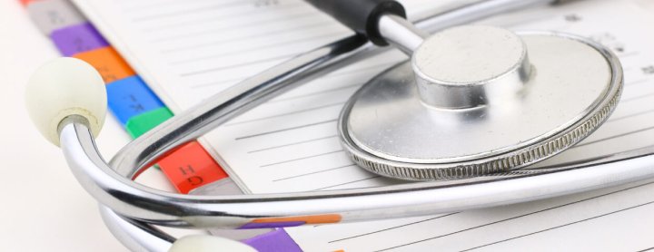 Medical file folder under stethoscope