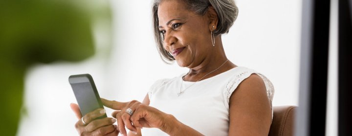 Woman smiling at phone screen