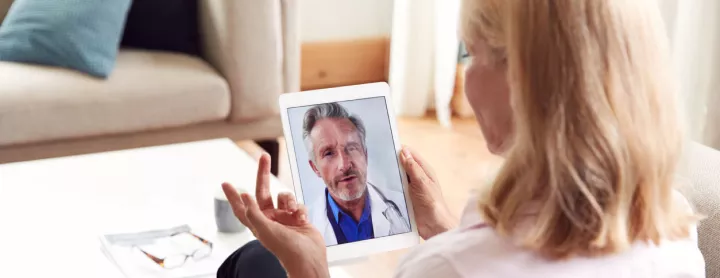 Female patient explains health concerns to doctor over telemedicine visit