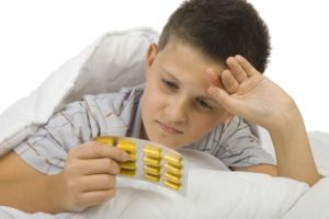 medicated kids Boy holding packet of pills