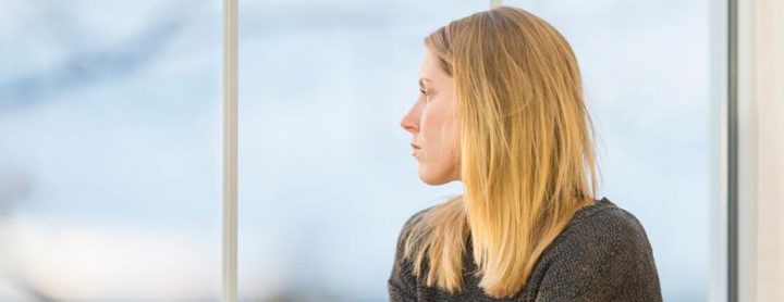 stoic girl looking out a window