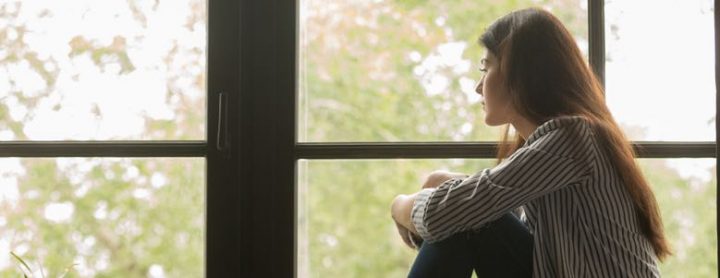 stoic woman looking out a window