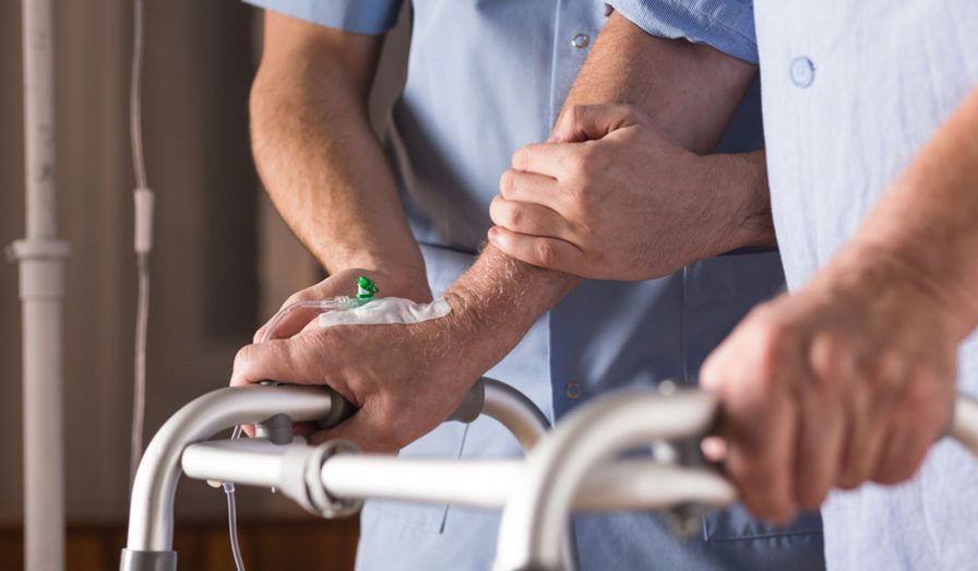 Patient being assisted with walker