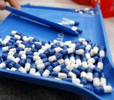 FDA reviews Pradaxa again sorting white and blue Pradaxa pills