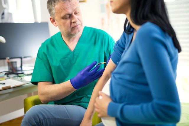 Pregnant woman getting shots